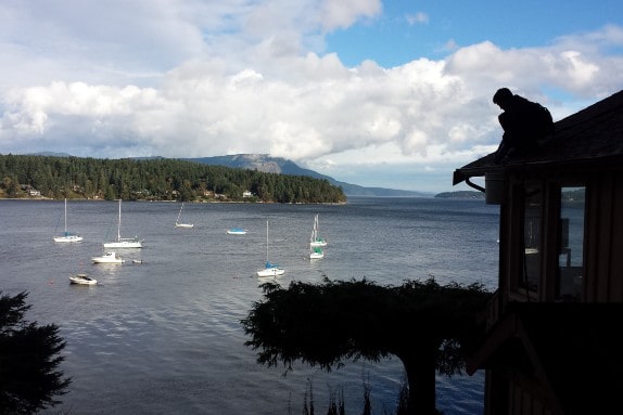 Man on roof overlooking bay